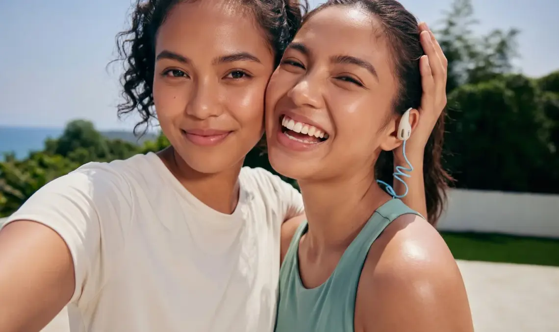 Two friends laughing together outdoors