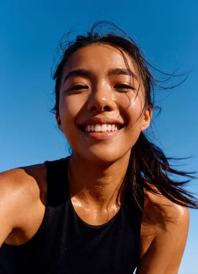 Portrait of a smiling woman in the sun